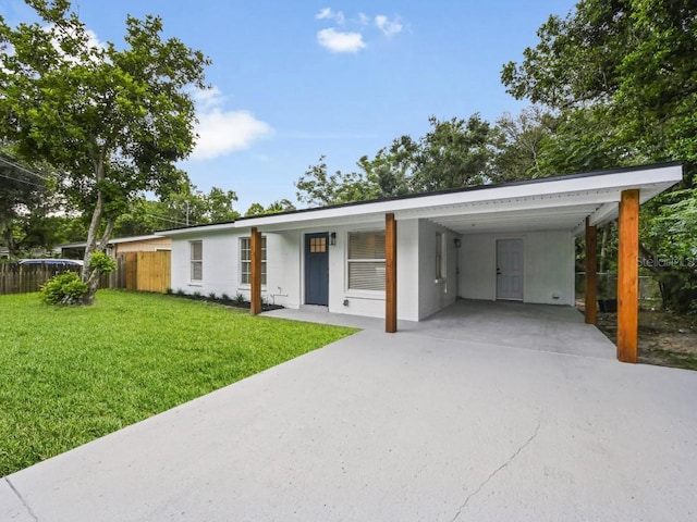 view of front of house with a front yard and a carport