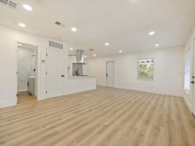 unfurnished living room featuring light hardwood / wood-style floors