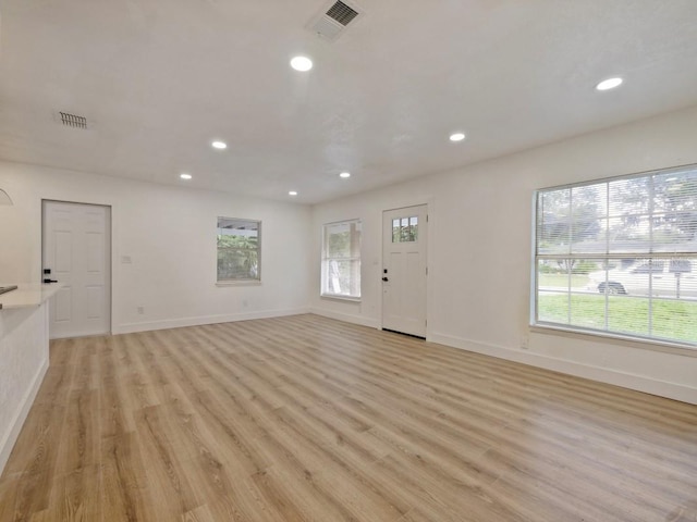 unfurnished living room featuring light hardwood / wood-style floors