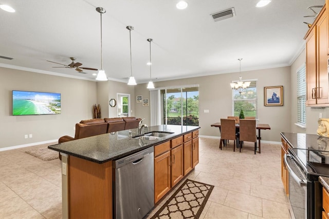 kitchen featuring visible vents, an island with sink, decorative light fixtures, stainless steel appliances, and a sink