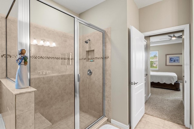 full bath with ensuite bathroom, a stall shower, tile patterned flooring, and baseboards