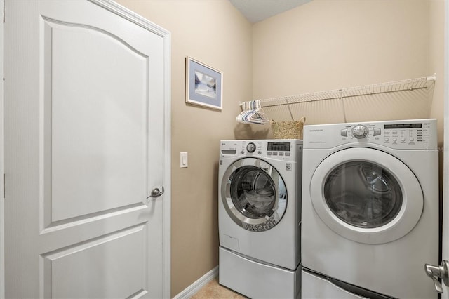 laundry area featuring laundry area, independent washer and dryer, and baseboards