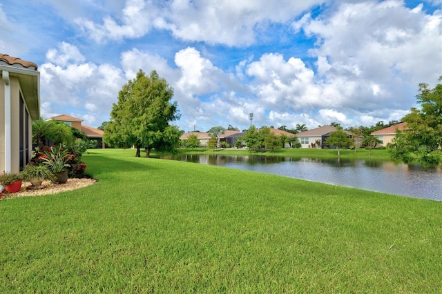 view of yard featuring a water view and a residential view