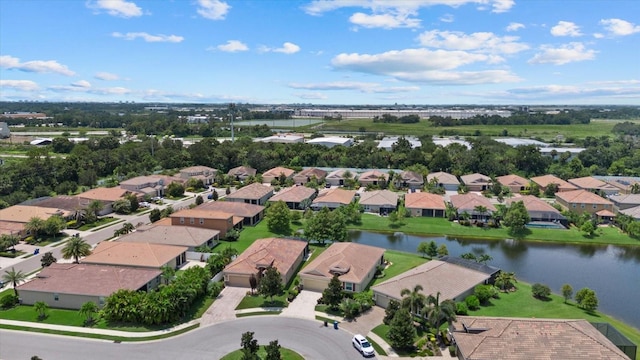 birds eye view of property with a water view and a residential view