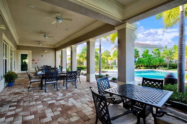 view of patio / terrace with outdoor dining area, an outdoor pool, and ceiling fan