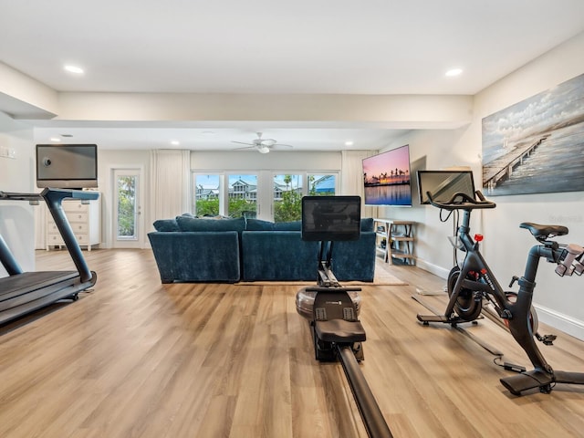 exercise room featuring hardwood / wood-style floors, a wealth of natural light, and ceiling fan