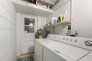 washroom featuring electric water heater and independent washer and dryer