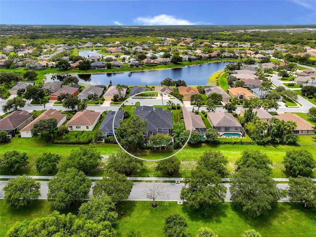 birds eye view of property with a water view