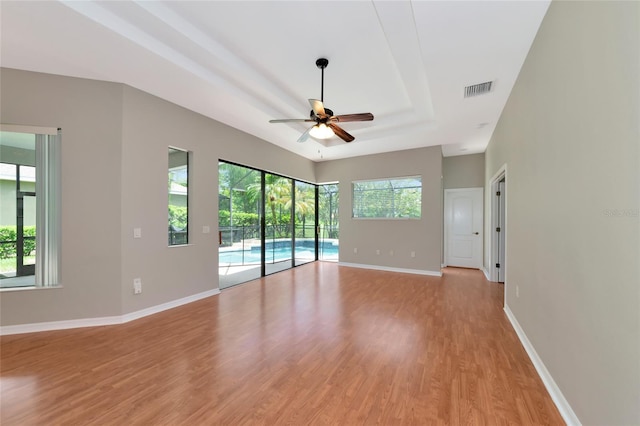 unfurnished room featuring plenty of natural light, light hardwood / wood-style floors, and ceiling fan