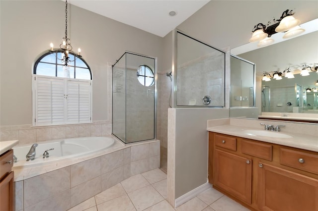 bathroom with plus walk in shower, vanity, and tile patterned flooring