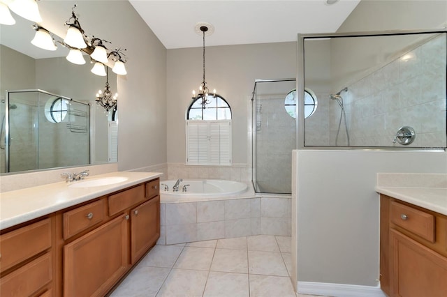 bathroom featuring independent shower and bath, an inviting chandelier, vanity, and tile patterned floors