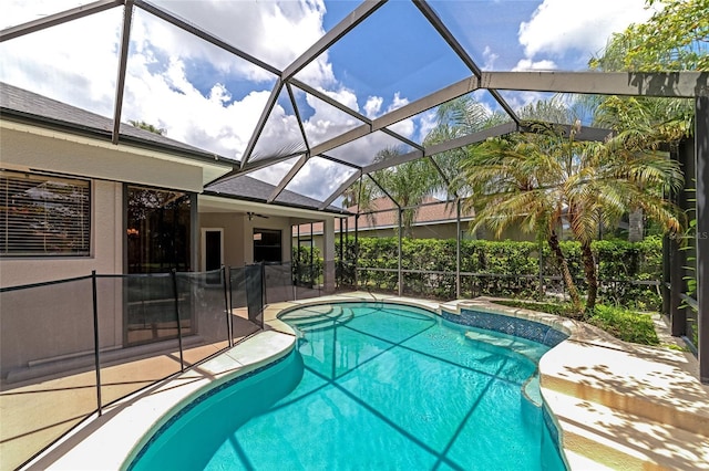 view of pool with glass enclosure