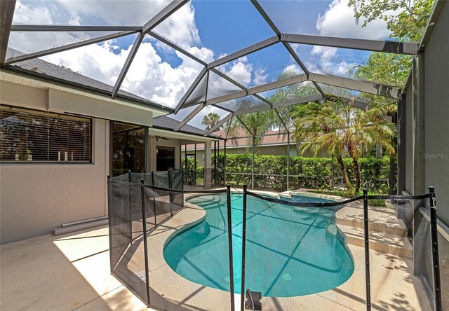 view of pool featuring an in ground hot tub, a patio, and a lanai