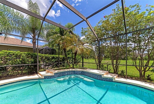 view of pool featuring glass enclosure