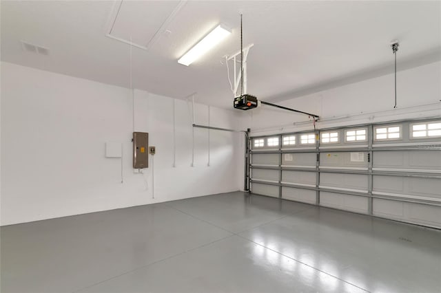 garage featuring electric panel and a garage door opener