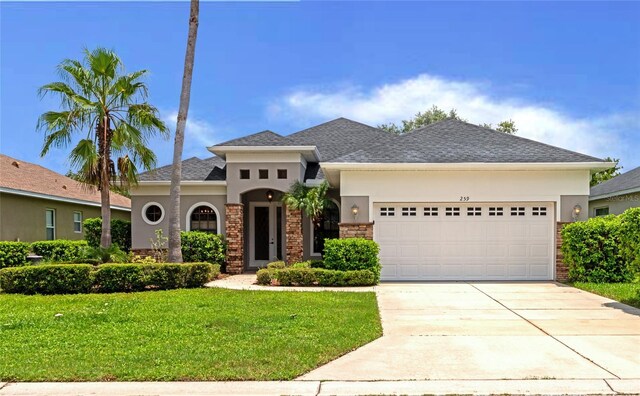 view of front of home featuring a garage and a front lawn