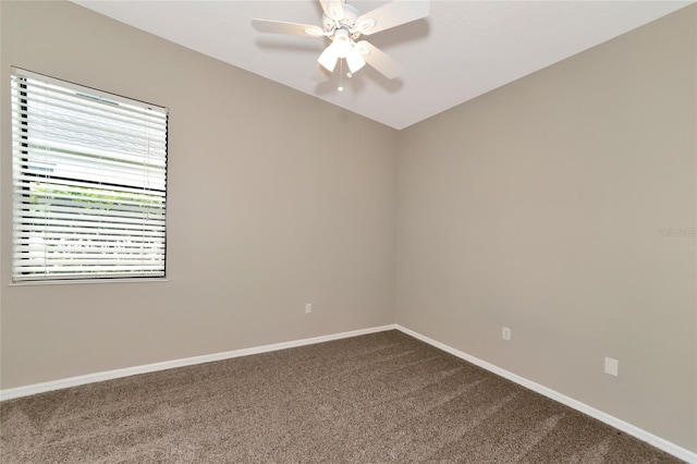 carpeted spare room featuring ceiling fan