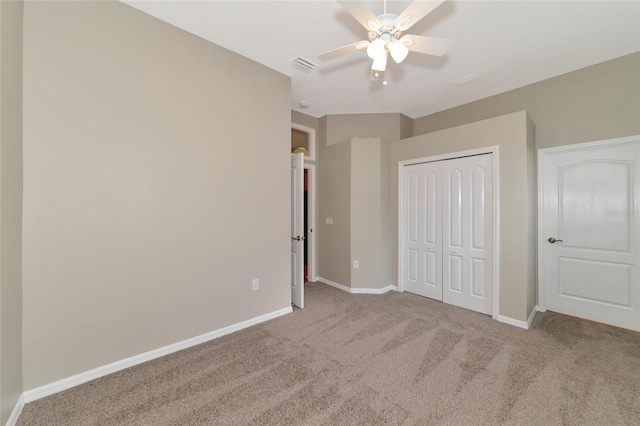 unfurnished bedroom with ceiling fan, carpet flooring, and a closet