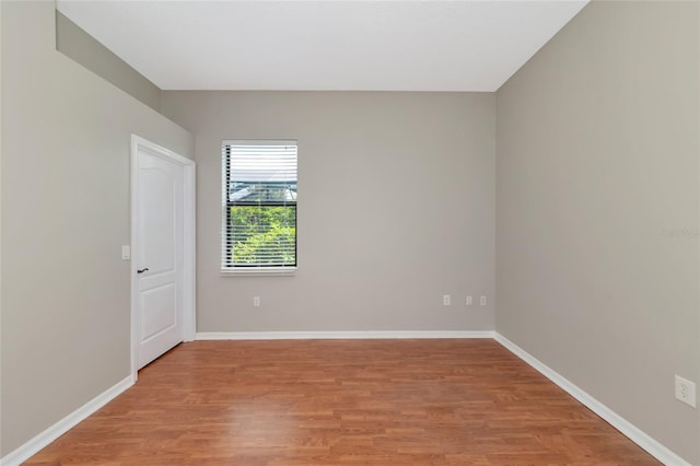 unfurnished room with hardwood / wood-style floors