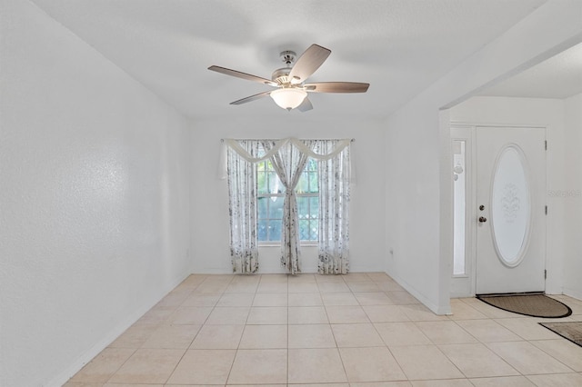 tiled foyer entrance with ceiling fan