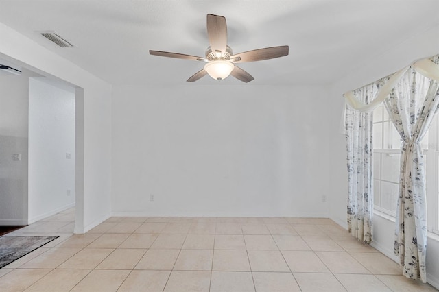 unfurnished room featuring light tile patterned flooring and ceiling fan