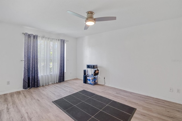 miscellaneous room featuring ceiling fan and light hardwood / wood-style flooring