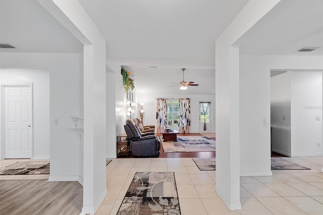 hallway with light hardwood / wood-style floors