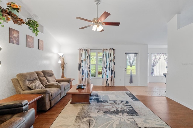 tiled living room featuring lofted ceiling and ceiling fan