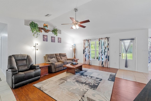 living room with vaulted ceiling, hardwood / wood-style floors, and ceiling fan