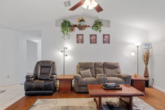 living room featuring lofted ceiling, light hardwood / wood-style flooring, and ceiling fan