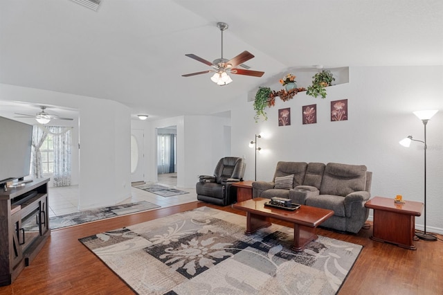 living room with lofted ceiling, hardwood / wood-style flooring, and ceiling fan