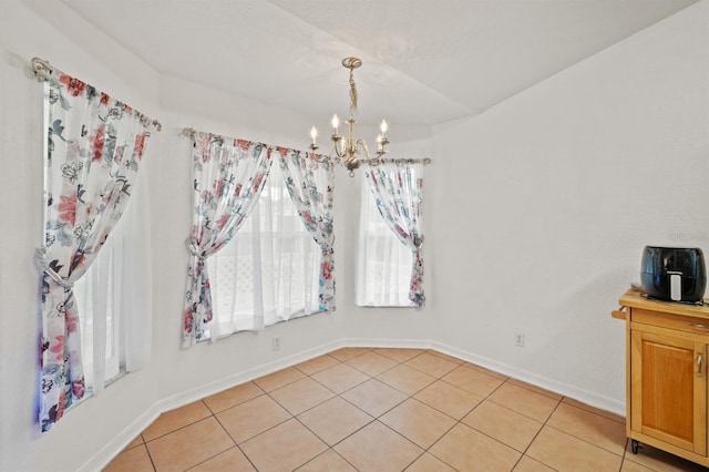 tiled dining room featuring a chandelier