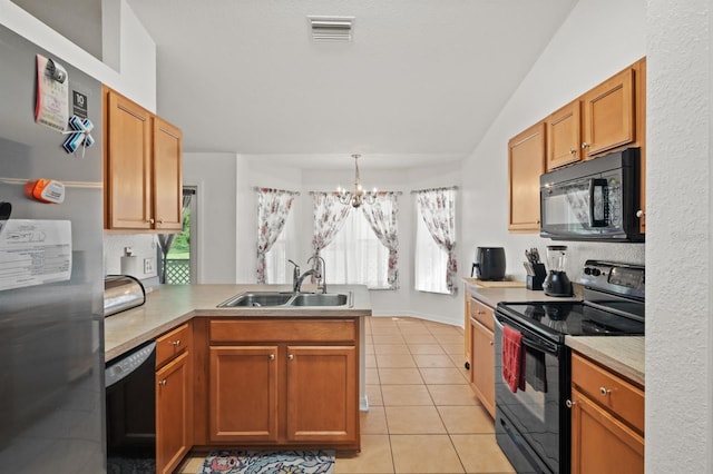 kitchen featuring black appliances, sink, kitchen peninsula, light tile patterned flooring, and a chandelier