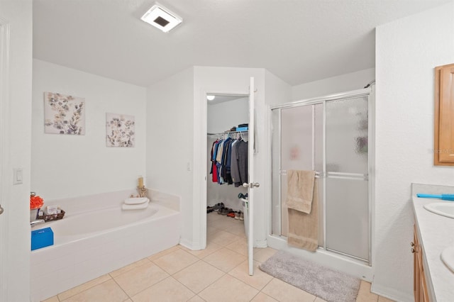 bathroom featuring vanity, shower with separate bathtub, and tile patterned flooring