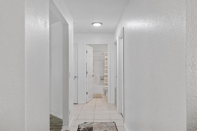 hallway with light tile patterned floors