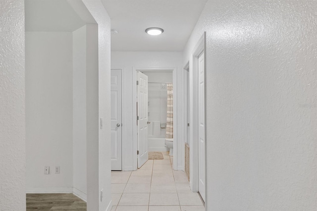 corridor featuring light tile patterned flooring