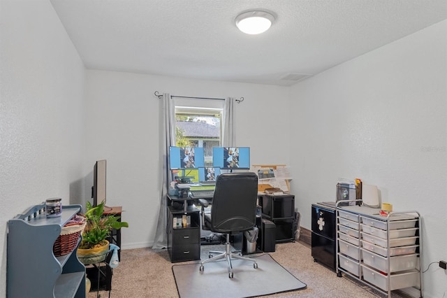 office with a textured ceiling and light colored carpet