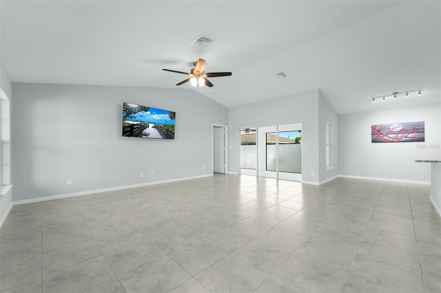 tiled empty room with ceiling fan, track lighting, and vaulted ceiling