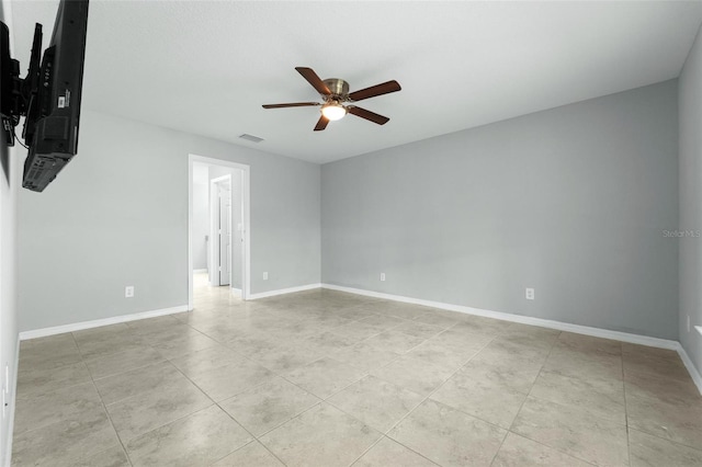 tiled empty room featuring ceiling fan