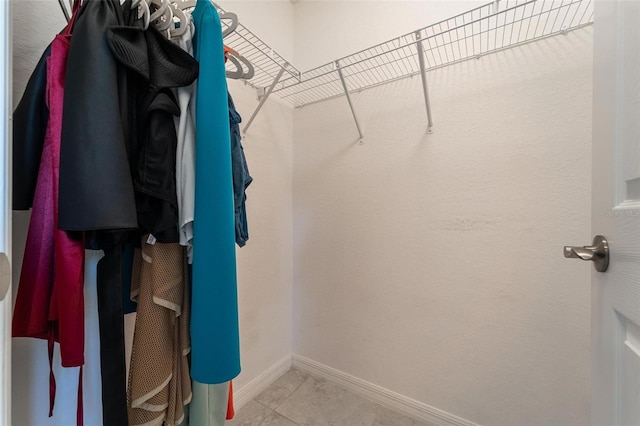 spacious closet with light tile patterned floors