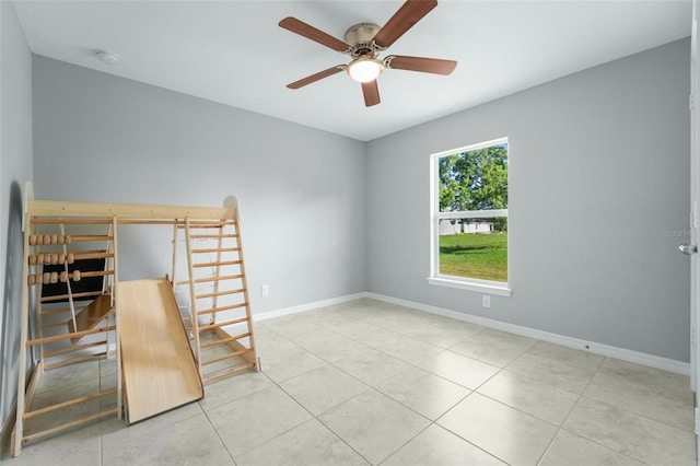 unfurnished office with light tile patterned floors and ceiling fan