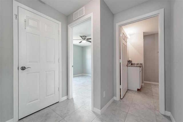 hall with light tile patterned floors