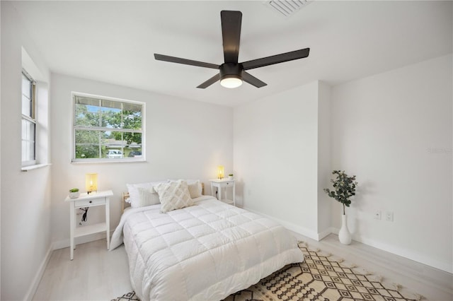 bedroom with light hardwood / wood-style flooring and ceiling fan