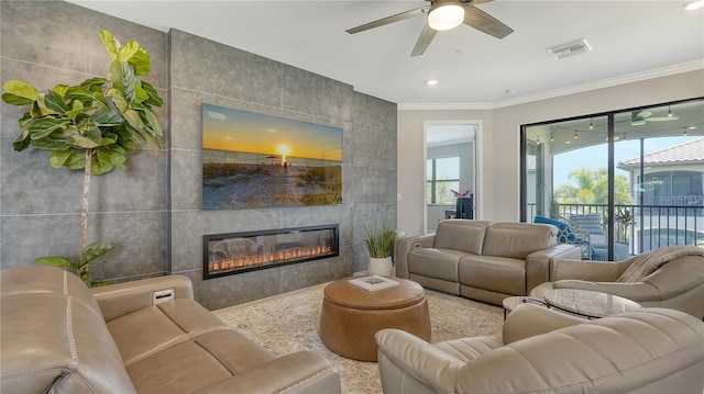 living room with ceiling fan, a fireplace, tile walls, and ornamental molding