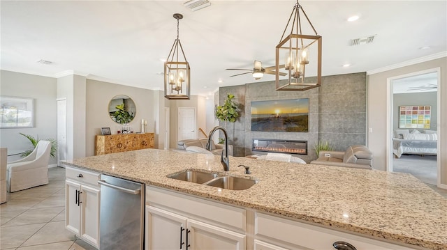 kitchen featuring white cabinets, decorative light fixtures, dishwasher, and sink