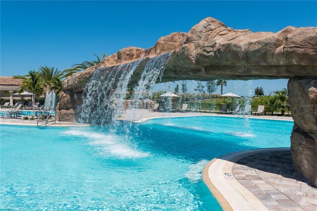 view of swimming pool featuring pool water feature