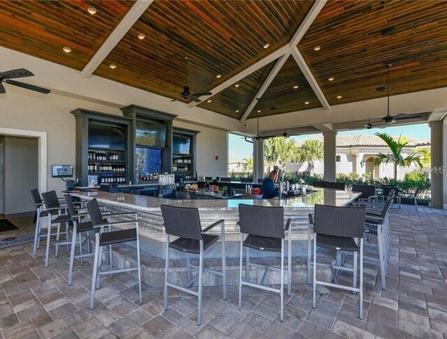 view of patio / terrace with exterior bar, a gazebo, and ceiling fan