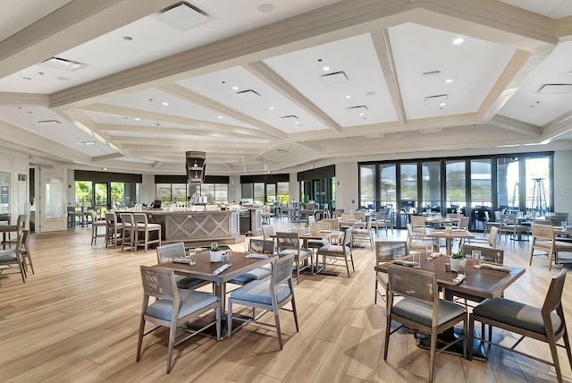 dining space with beamed ceiling, light hardwood / wood-style flooring, plenty of natural light, and crown molding