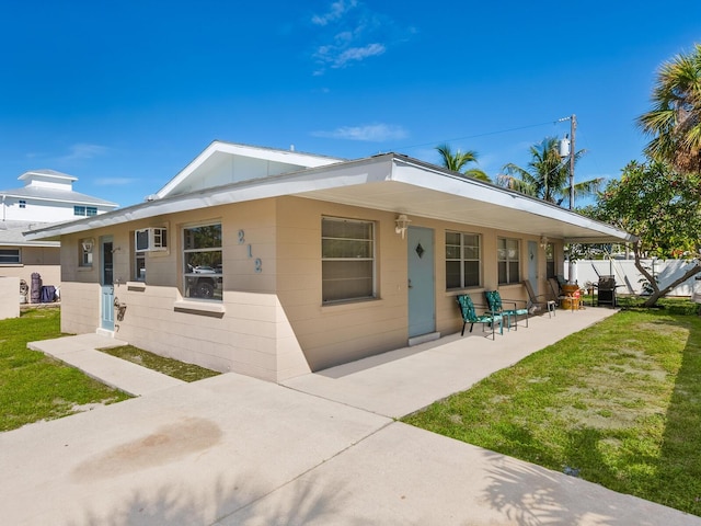 rear view of property with a yard and a patio area