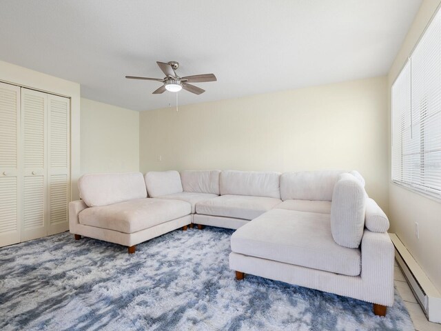 living room with a baseboard radiator and ceiling fan